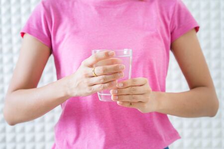 Female drinking from a glass of water. Health care conceptの写真素材