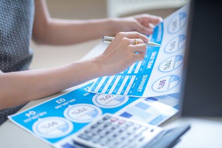 Asian business woman reviewing data in financial charts and graphs. Accountingの写真素材