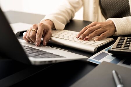 Business woman using a laptop computer at officeの写真素材
