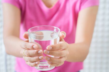 Female drinking from a glass of water. Health care conceptの写真素材
