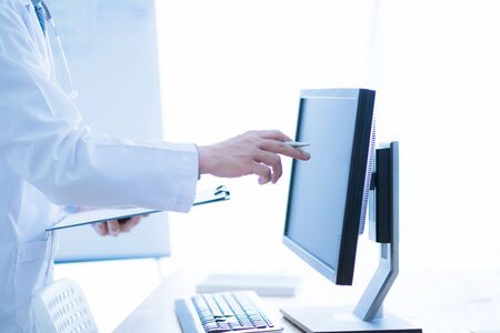 Close-up Of Male Doctor Filling The Medical Formの写真素材