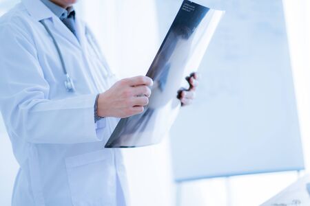 Close-up Of Male Doctor Filling The Medical Formの写真素材