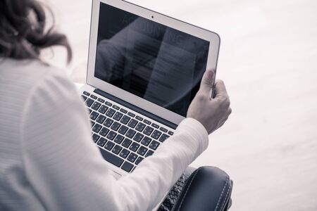 Asian business woman reviewing data in financial charts and graphs. Accountingの写真素材