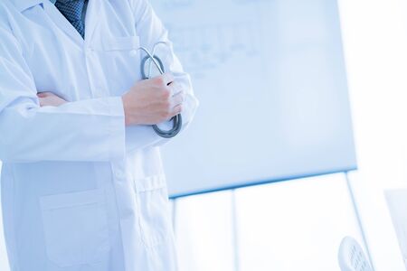 Close-up Of Male Doctor Filling The Medical Formの写真素材