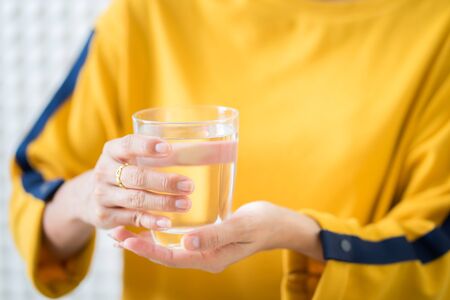 Female drinking from a glass of water. Health care conceptの写真素材