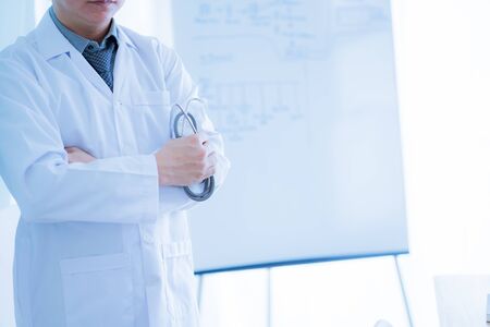 Close-up Of Male Doctor Filling The Medical Formの写真素材