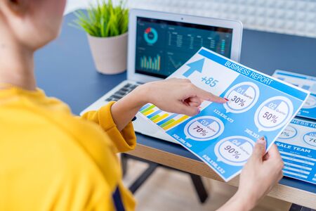 Business women reviewing data in financial charts and graphs. Accountingの写真素材