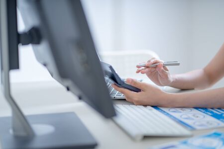 Asian business woman reviewing data in financial charts and graphs. Accountingの写真素材