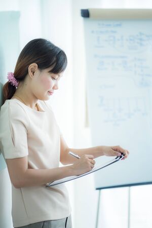 Portrait of young beautiful asian business woman in the office.の写真素材