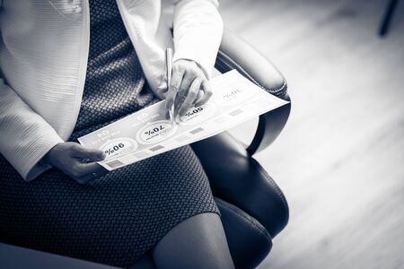 Asian business woman reviewing data in financial charts and graphs. Accountingの写真素材