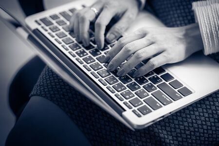 Asian business woman reviewing data in financial charts and graphs. Accountingの写真素材