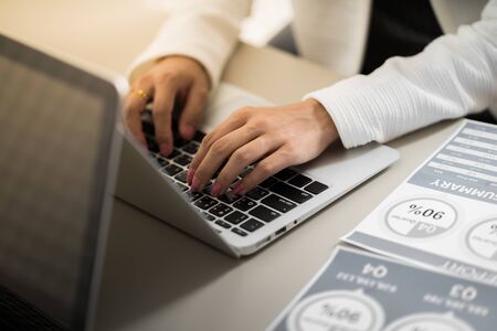Asian business woman reviewing data in financial charts and graphs. Accountingの写真素材