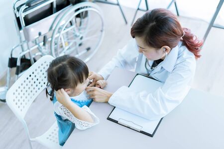 Asian cute girl visiting a doctorの写真素材