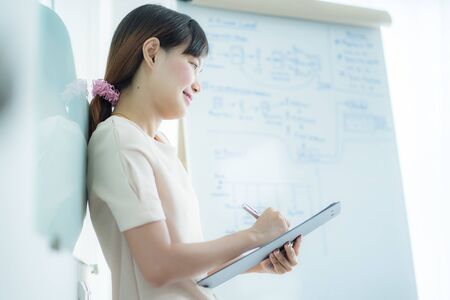 Portrait of young beautiful asian business woman in the office.の写真素材