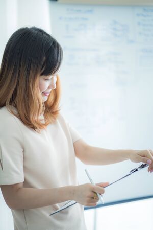 Portrait of young beautiful asian business woman in the office.の写真素材