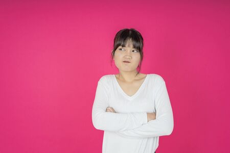 asian young casual style woman portrait isolated over pink background.の写真素材