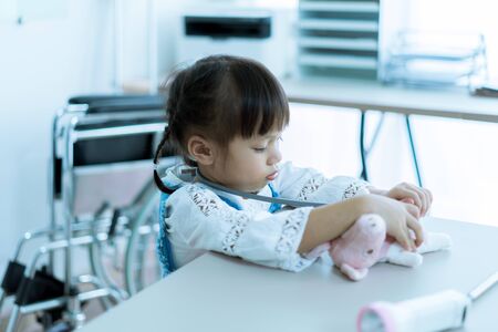 Asian little girl visiting a doctor. Medicine and children's therapy conceptの写真素材