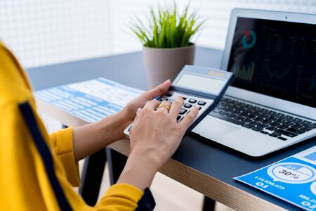 Business women reviewing data in financial charts and graphs. Accountingの写真素材