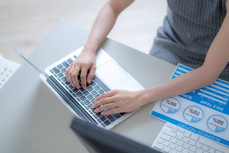 Asian business woman reviewing data in financial charts and graphs. Accountingの写真素材