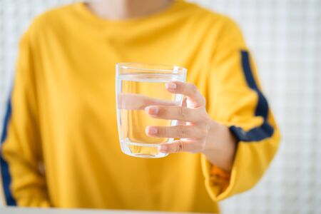 Female drinking from a glass of water. Health care conceptの写真素材