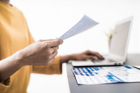 Business women reviewing data in financial charts and graphs. Accountingの写真素材