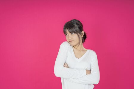 asian young casual style woman portrait isolated over pink background.の写真素材