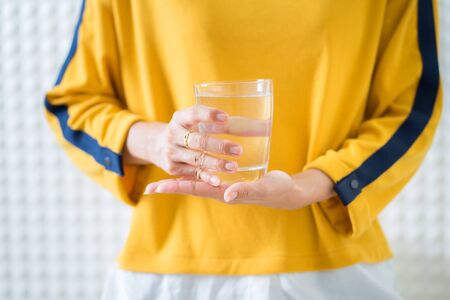Female drinking from a glass of water. Health care conceptの写真素材