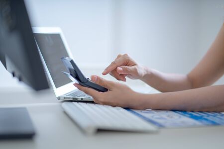 Asian business woman reviewing data in financial charts and graphs. Accountingの写真素材