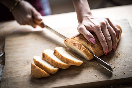 Fresh bread on the kitchen table The healthy eating and traditional bakery concept. Whole grain...