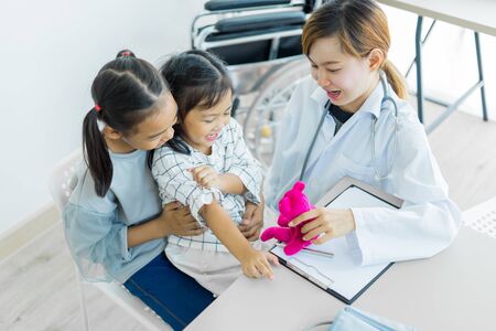 Asian cute girl visiting a doctor. Medicine and children's therapy conceptの写真素材