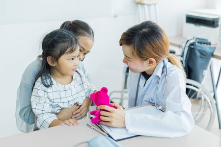 Asian cute girl visiting a doctor. Medicine and children's therapy conceptの写真素材