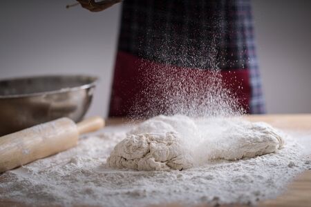 Making dough by female hands at bakeryの写真素材