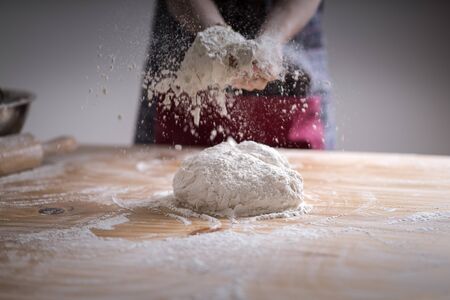 Making dough by female hands at bakeryの写真素材