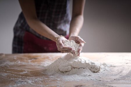 Making dough by female hands at bakeryの写真素材