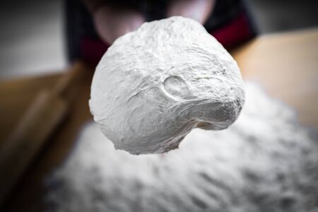 Making dough by female hands at bakery