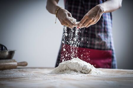 Making dough by female hands at bakery