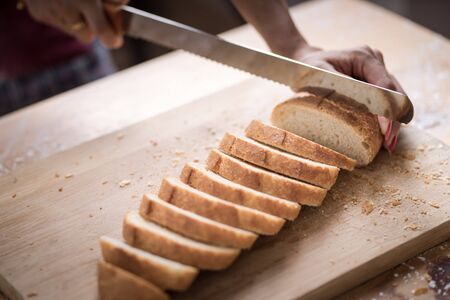 Fresh bread on the kitchen table The healthy eating and traditional bakery concept. Whole grain...