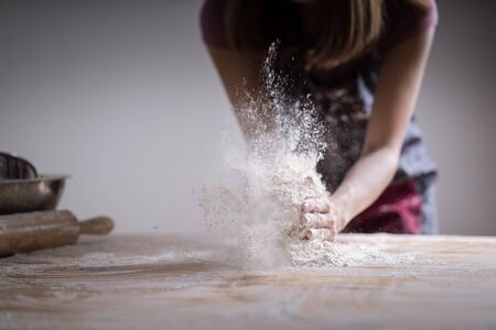 Making dough by female hands at bakeryの写真素材