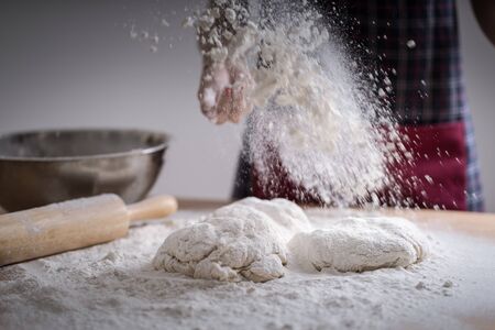 Making dough by female hands at bakeryの写真素材
