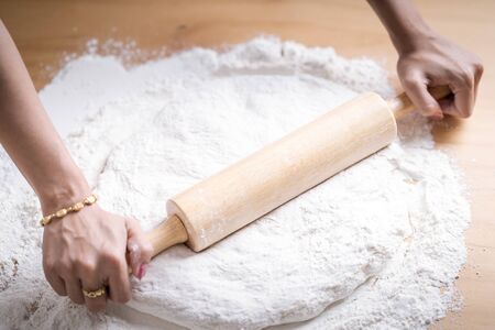 Making dough by female hands at bakeryの写真素材