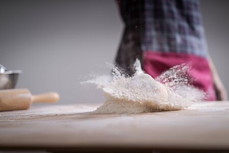 Fresh bread on the kitchen table. Fresh bread on table close-up in flour placer. The healthy eating and traditional bakery concept. Rustic styleの写真素材