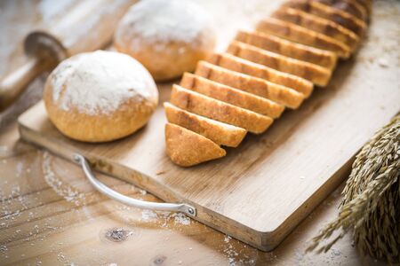 Different fresh bread on wooden tableの写真素材