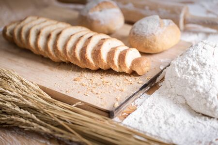 Different fresh bread on wooden tableの写真素材