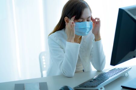 Asian woman using the medical face mask in officeの写真素材