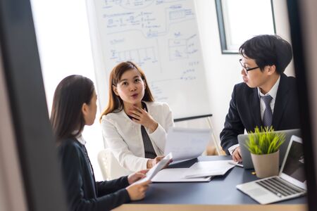 Group of business people busy discussing financial matter during meeting. Asian peopleの写真素材