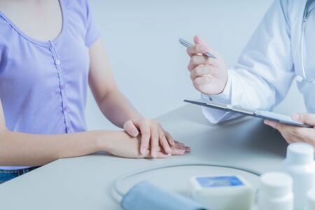 Doctors and patient talking about therapy. Asian people