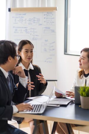 Group of business people busy discussing financial matter during meeting. Asian people