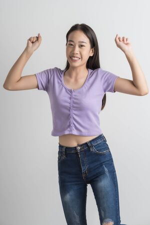 Do not miss. Young asian woman shouting. Shout. Crying emotional woman screaming on pink studio background. Female half-length portrait. Human emotions, facial expression concept. Trendyの写真素材