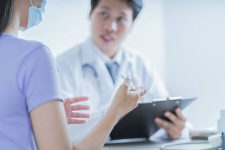 Doctors and patient talking about therapy. Asian people