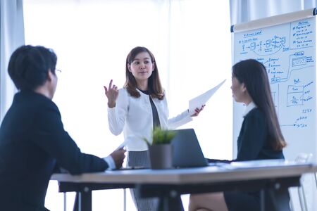 Group of business people busy discussing financial matter during meeting. Asian peopleの写真素材